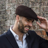 Model wearing men's brown newsboy cap