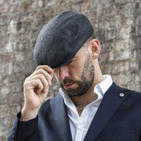 Men's black flat ivy hat on model