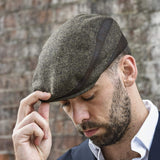 Men's brown flat ivy hat on model