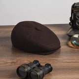 Men's brown driving cap on table